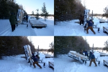 Boardwalk installation during winter 2014 showing unloading of dock section from custom snowmobile trailer in fen.